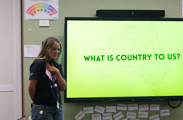 Female student presenter at front of classroom
