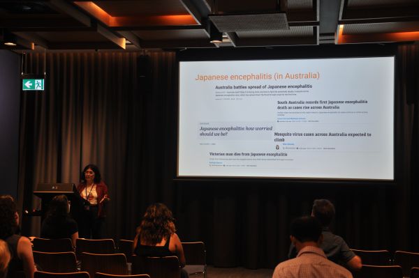A speaker at the podium next to a slide titled 'Japanese encephalitis (in Australia)'