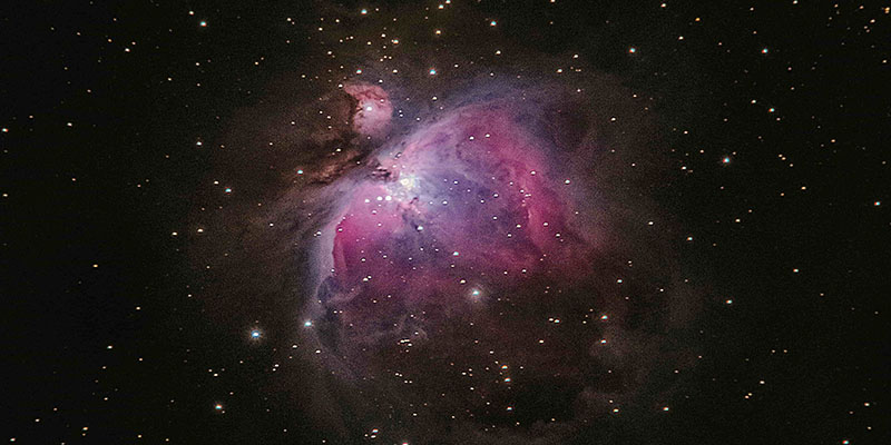 Pink and purple nebula in space