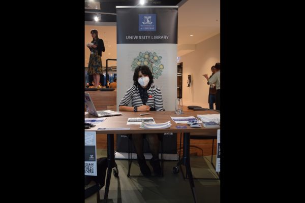 The university library booth, staffed by a seated member of staff 