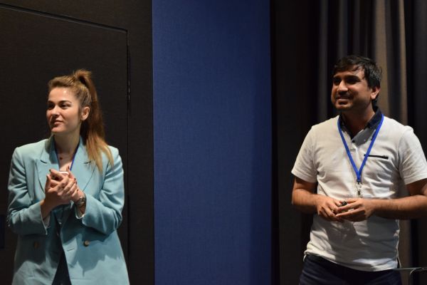 A presenter and session chair side-by-side