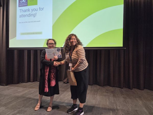 The Dean of Science, Moira O'Bryan, presenting a certificate to a speaker