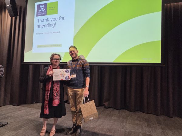 The Dean of Science, Moira O'Bryan, presenting a certificate to a speaker