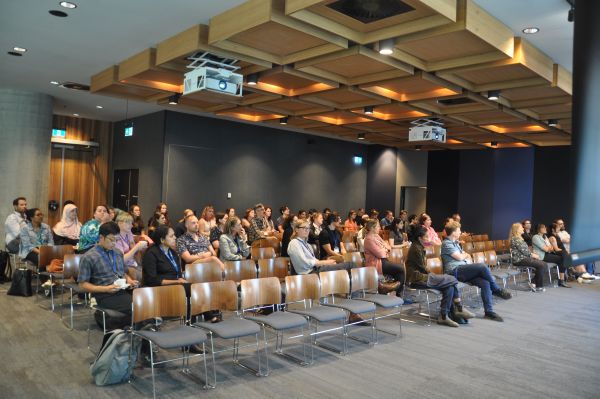 Conference attendees watching a presentation