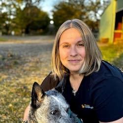 Jade Fountain smiling at camera with dog