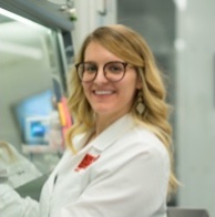 Jenna Hall, in a lab coat