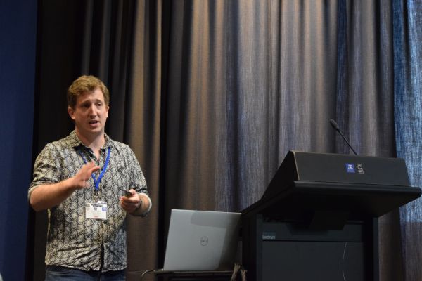 A conference speaker behind the podium