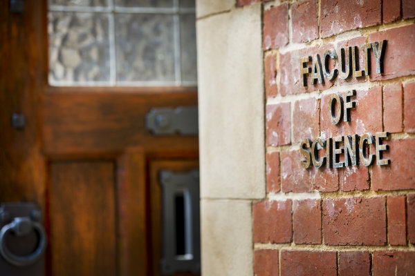 Picture of a sign reading Faculty of Science on a red brick building.