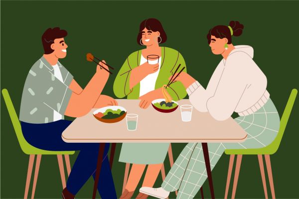 Illustration of three people sitting around a table and enjoying a meal together.