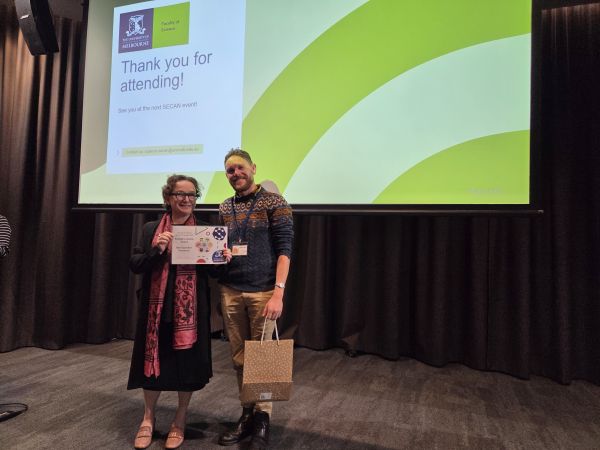 The Dean of Science, Moira O'Bryan, presenting a certificate to a speaker