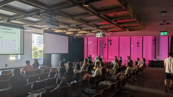 Audience members looking at a slide