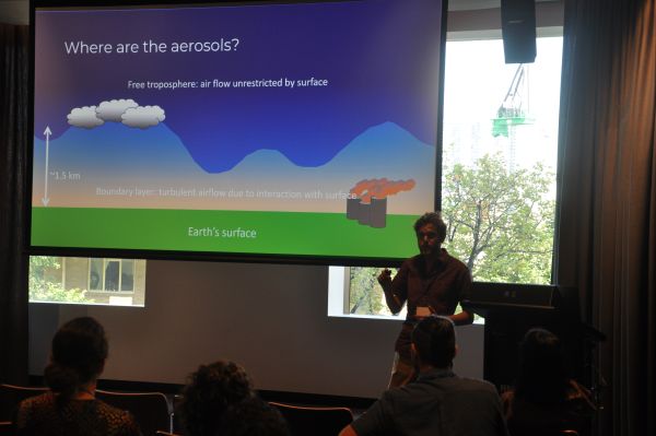 A speaker in front of a slide titled 'Where are the aerosols?'