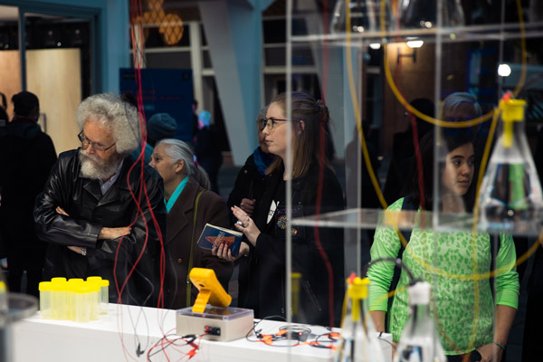 Guests view the Urinotron exhibit at the Science Dean's Winter Reception