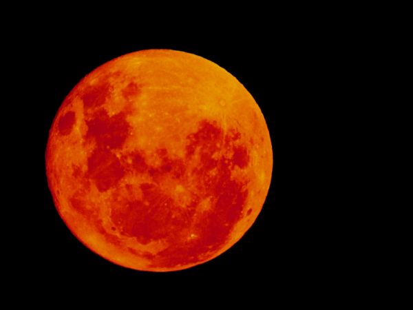 Close up of a full moon with smoke filtering around it