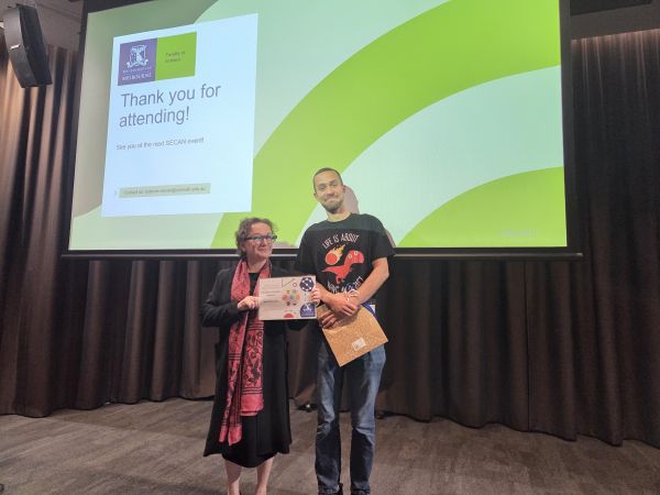 The Dean of Science, Moira O'Bryan, presenting a certificate to a speaker