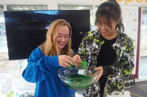 Students with bowl of slime
