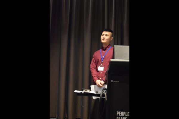A conference presenter behind the podium