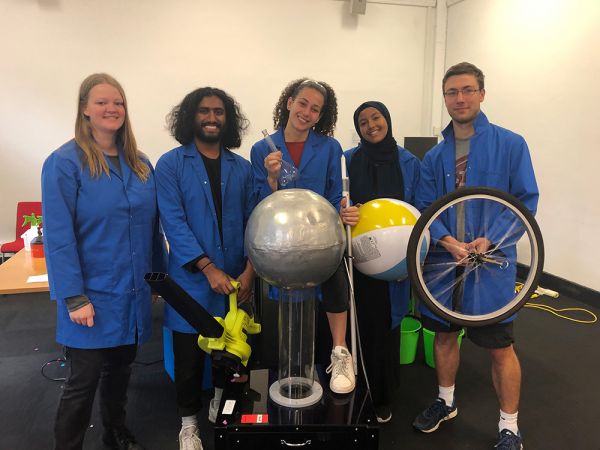 five people in blue lab coats
