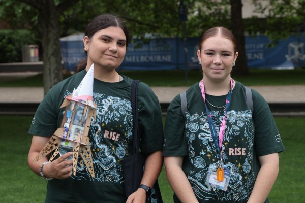 Two students and their plastic bottle rocket