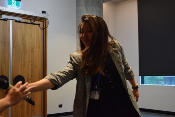 A session chair handing the microphone to an audience member