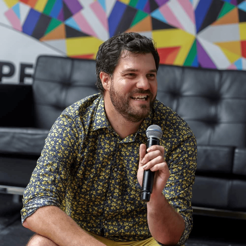 Dr Cam Raw holding a microphone