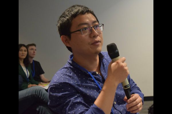 An audience member holding the microphone to ask a question