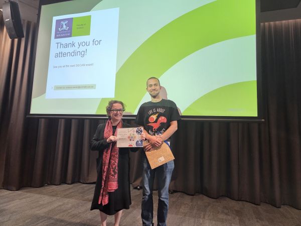 The Dean of Science, Moira O'Bryan, presenting a certificate to a speaker