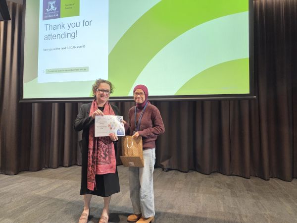 The Dean of Science, Moira O'Bryan, presenting a certificate to a speaker