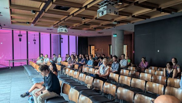 A wide-angle shot of the audience watching a talk