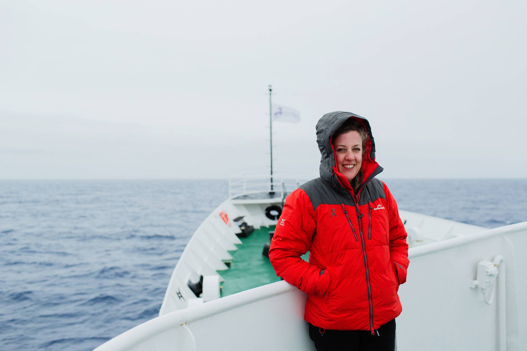 Dr Marie Clark, in a thick coat, standing on a ship in the water