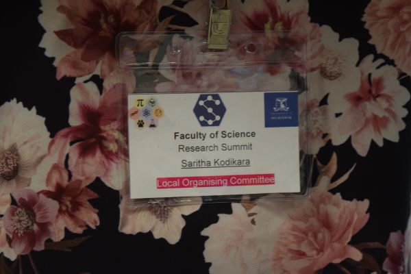 A close-up on a conference badge, reading 