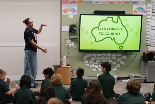 Female student presenter at front of classroom