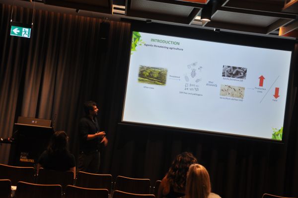 A speaker next to a slide titled 'Introduction - Agents threatening agriculture'
