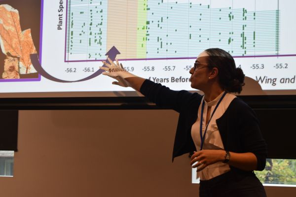 A conference speaker and the bottom of their slide