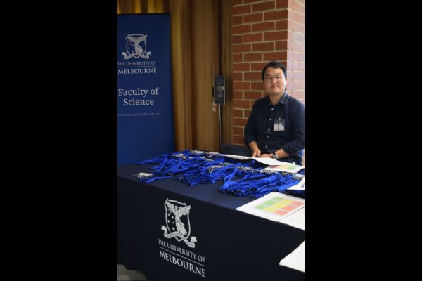 A conference organiser staffing the registration table