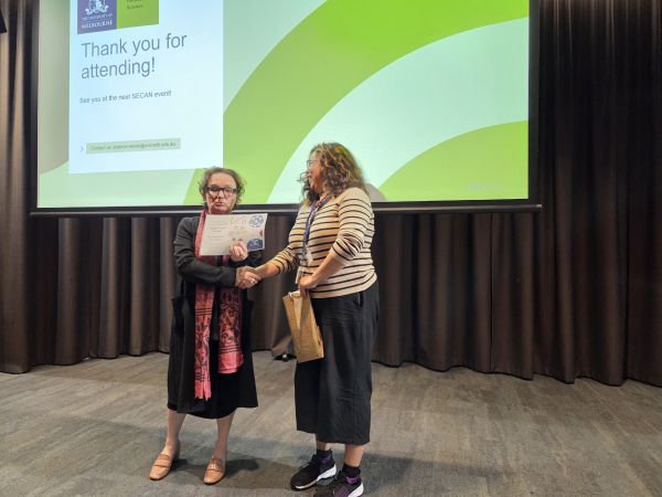 The Dean of Science, Moira O'Bryan, presenting a certificate to a speaker