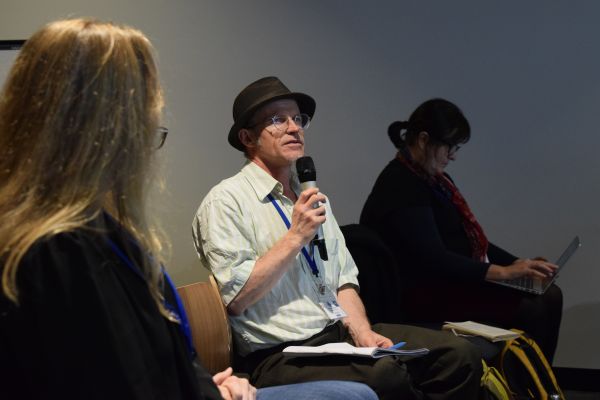 Several audience members, one holding the microphone