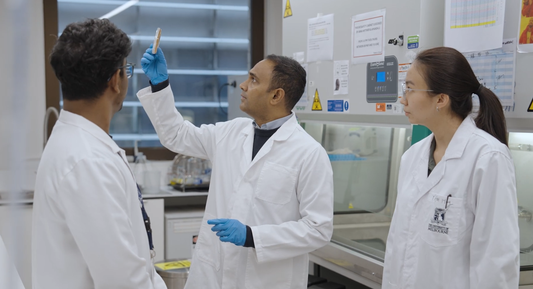 Senaka in lab with students