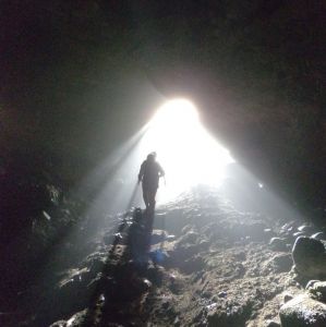 Light shining through a cave entrance from below the surface